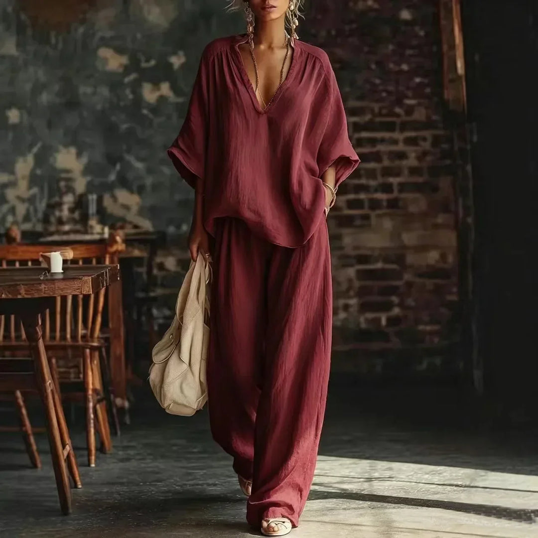 Stylish women's crinkled two-piece lounge set with plunging neckline & wide-leg pants. Perfect for comfort.