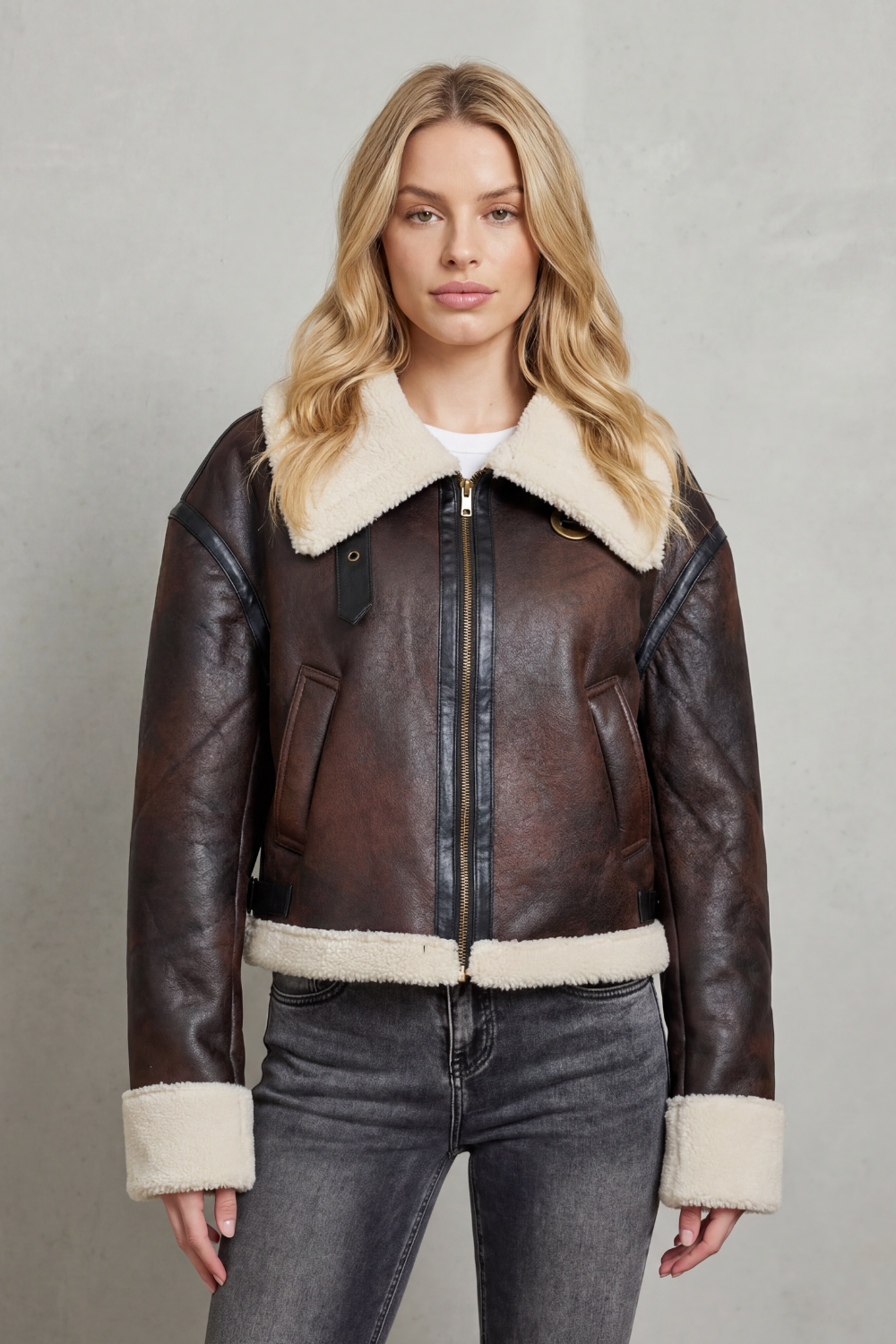 Stylish women's cropped aviator jacket featuring warm shearling-style trim, ideal for casual layered looks.