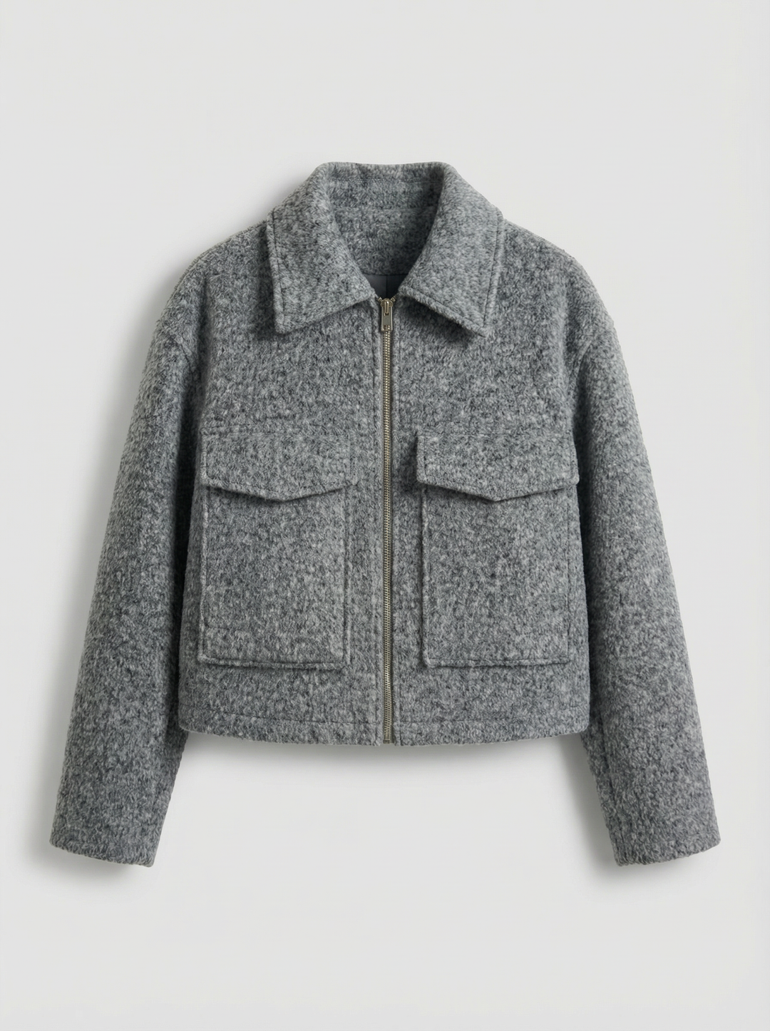 Chic women's cropped gray zip jacket with functional pockets. A stylish layering piece for modern spring/autumn fashion.