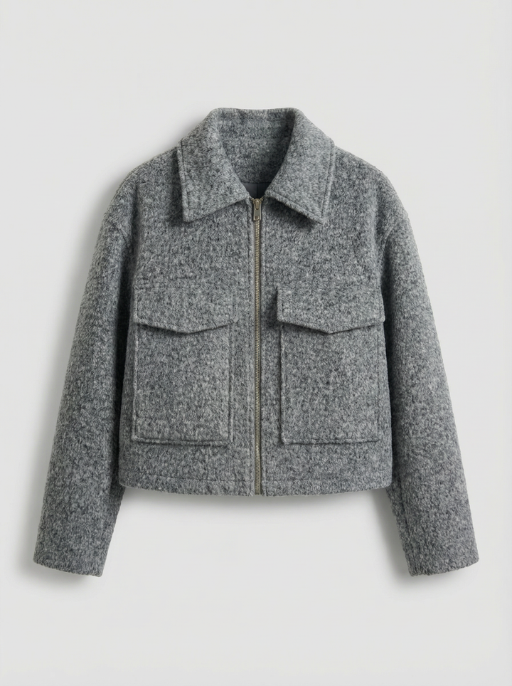Chic women's cropped gray zip jacket with functional pockets. A stylish layering piece for modern spring/autumn fashion.