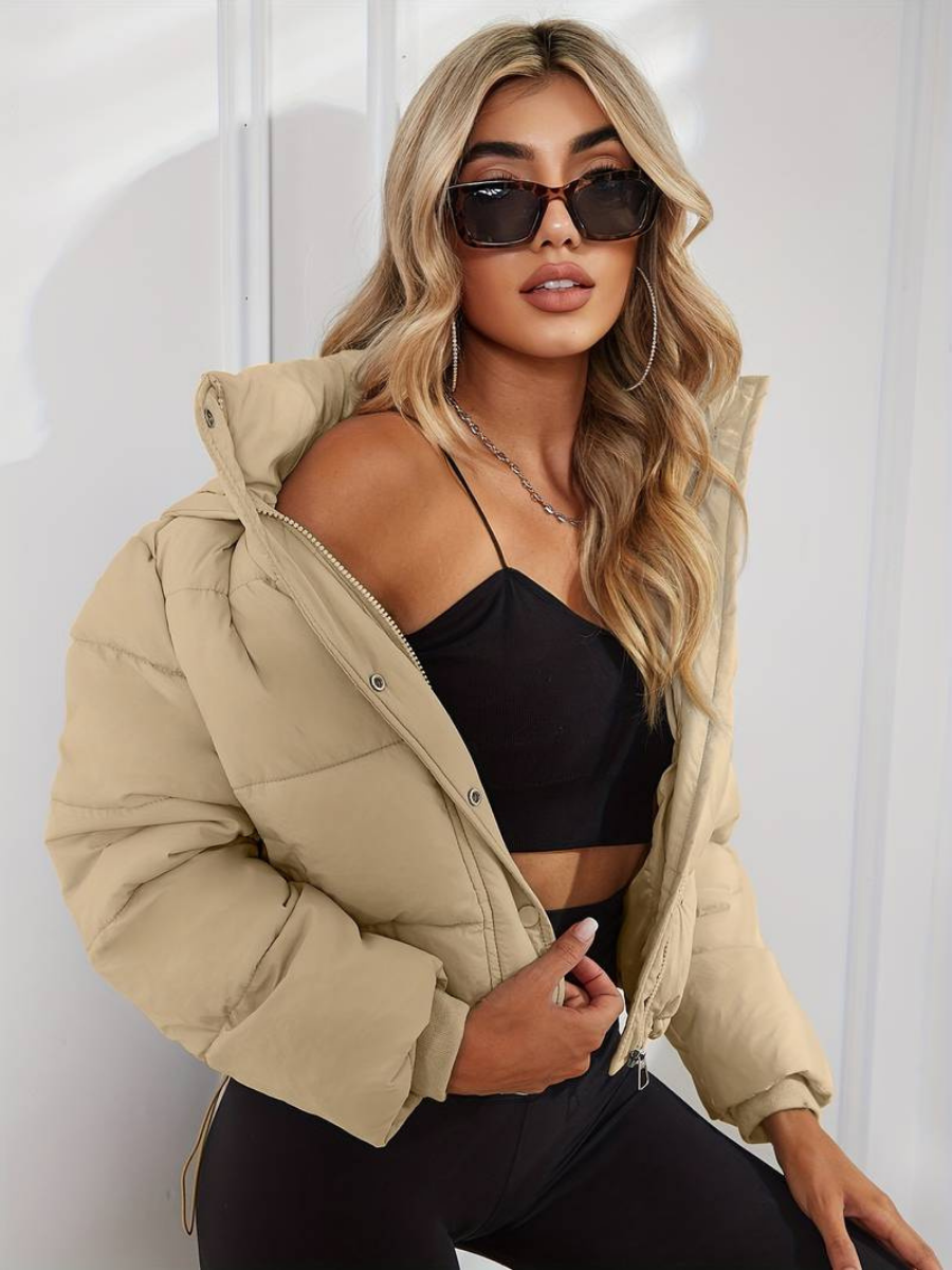 Model wearing a warm, cropped hooded puffer jacket for casual everyday style.