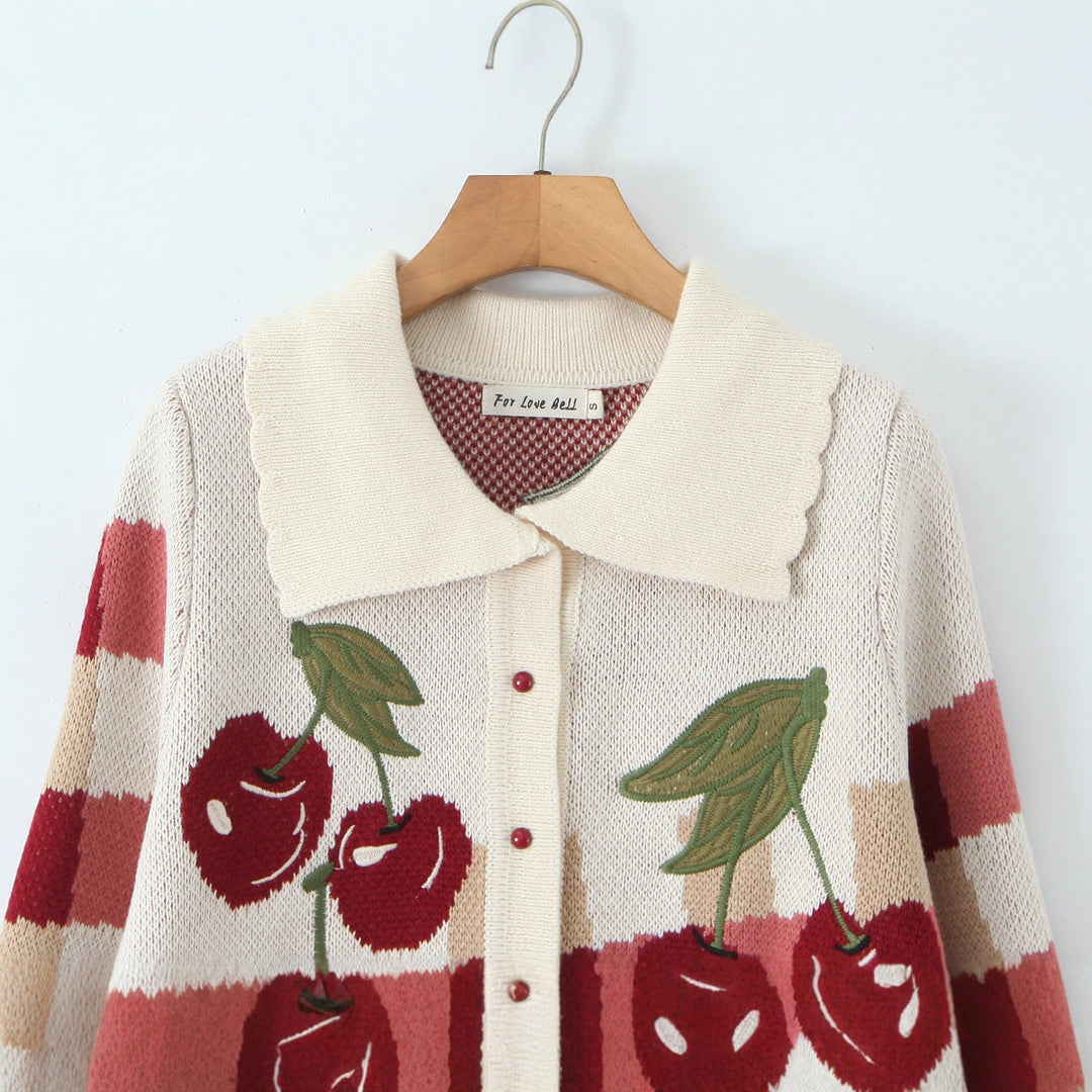 A trendy cropped knit jacket for women, showcasing a bold cherry blossom floral print.