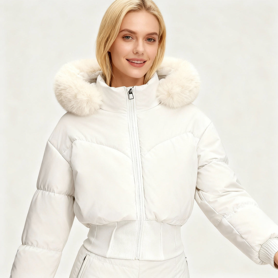 Cropped puffer jacket for women, featuring a plush faux fur hood & warm insulation. Essential winter fashion.