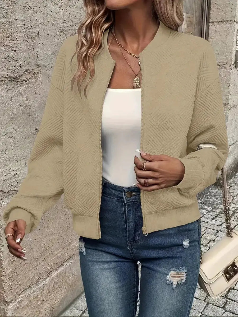 Fashionable women's cropped quilted bomber jacket with a practical zip-up closure for everyday style.