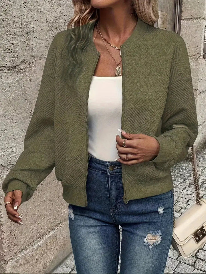 Zip-up cropped quilted bomber jacket for women, offering lightweight warmth and textured everyday style.