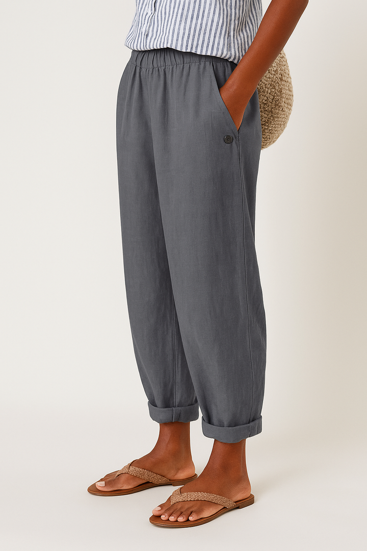 Detail shot of women's mid-rise straight leg cropped trousers, highlighting the fabric and side pockets.
