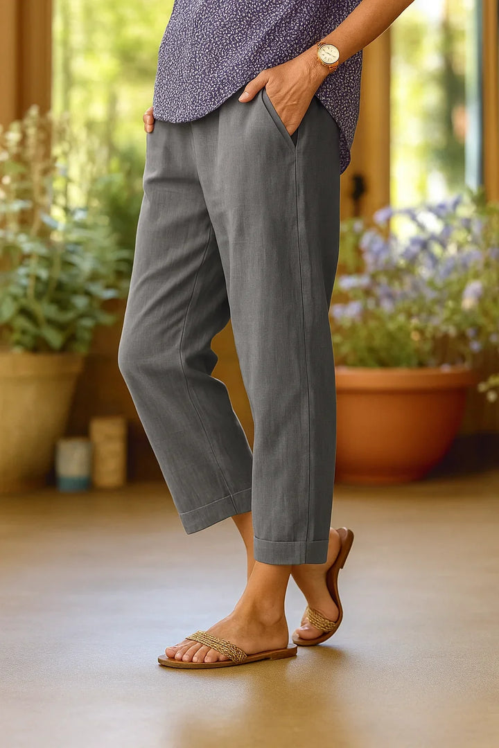 Versatile women's straight leg cropped trousers. Features comfortable fit, cuffed hem, and deep pockets.