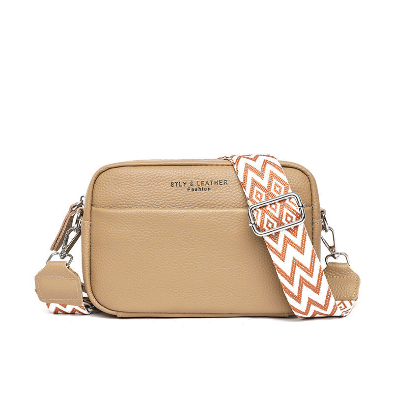 Practical women's crossbody bag in blue, with a durable pebbled design and adjustable strap for comfort.