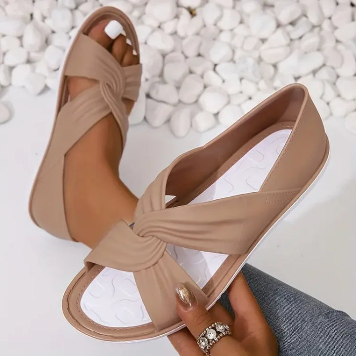 Stylish women's crossover sandals, designed for comfort & everyday wear. Features cushioned sole & open toe.