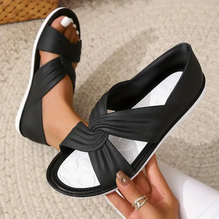 Slip-on women's flats: stylish crossover sandals with a plush cushioned sole for ultimate foot comfort.