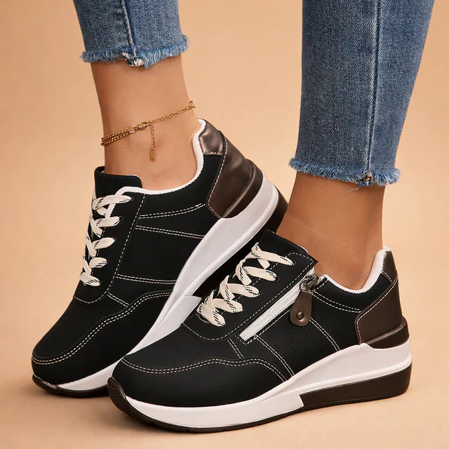 Stylish women's low-top fashion sneakers with perforated design, offering cushioned comfort.