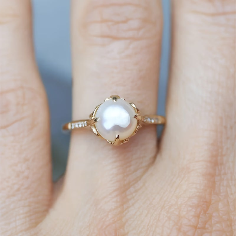 Elegant women's pearl and crystal ring, a delicate fashion statement piece, ideal gift for her.