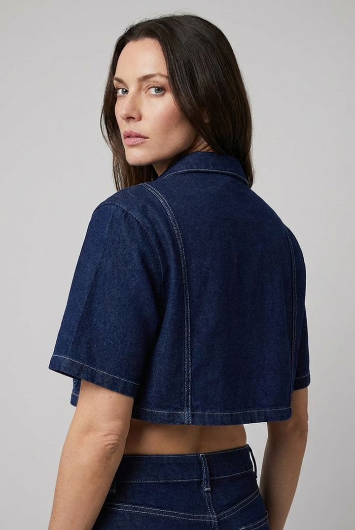 Stylish women's cropped denim-style shirt and matching mini skirt two-piece set for a trendy summer look.