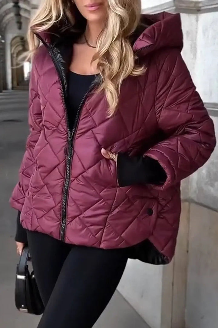 Warm women's zip-up hooded puffer jacket, diamond quilted for stylish and practical winter & fall fashion.