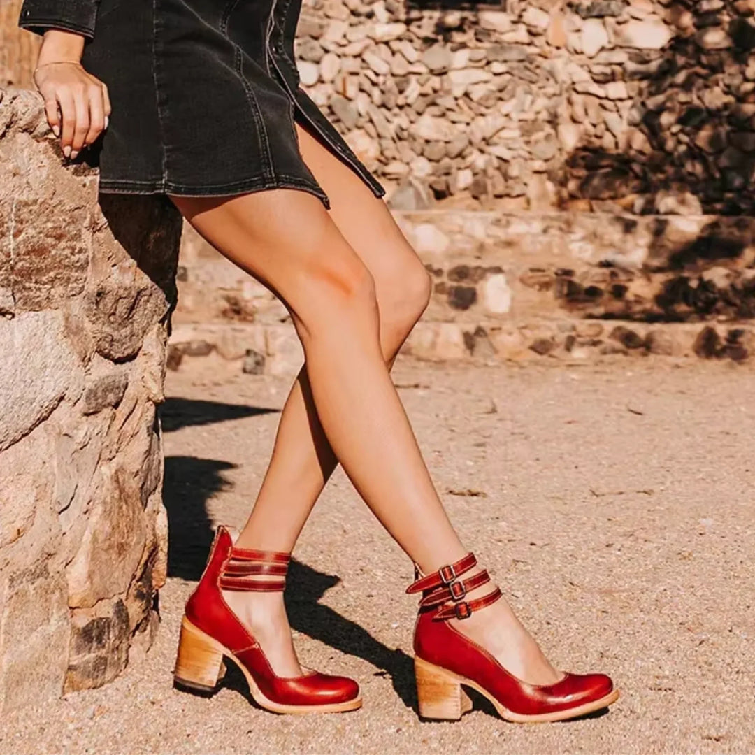 Front view of stylish women's distressed block heel sandals, showcasing buckled ankle straps.