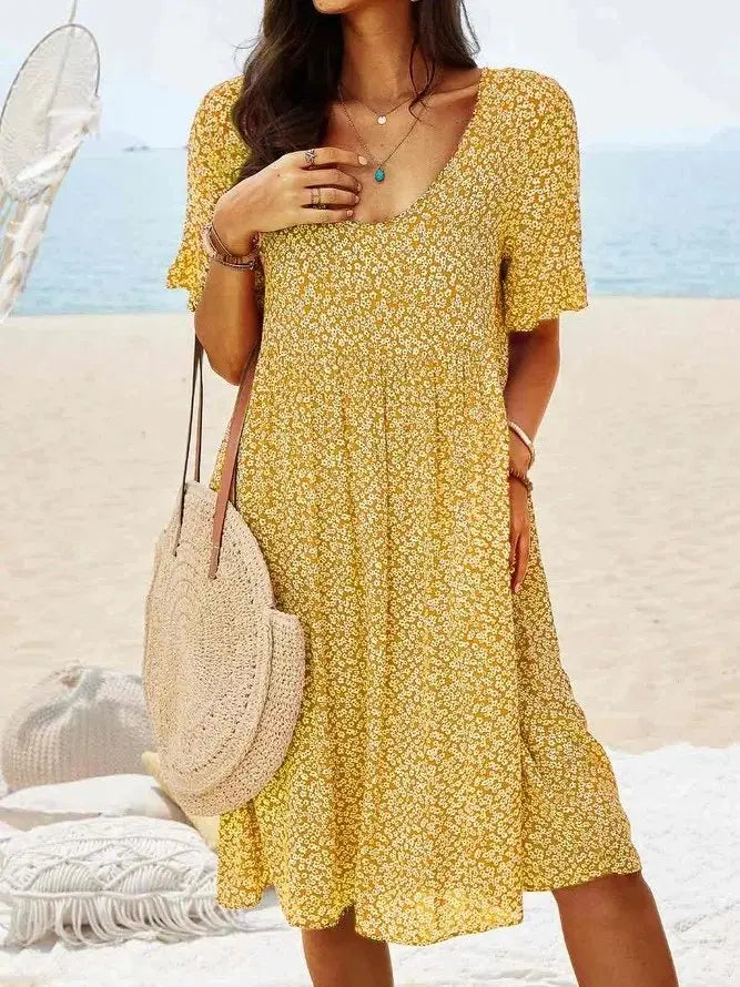 Casual women's ditsy floral mini summer dress with flutter sleeves. Comfortable and breezy for warm weather outings.