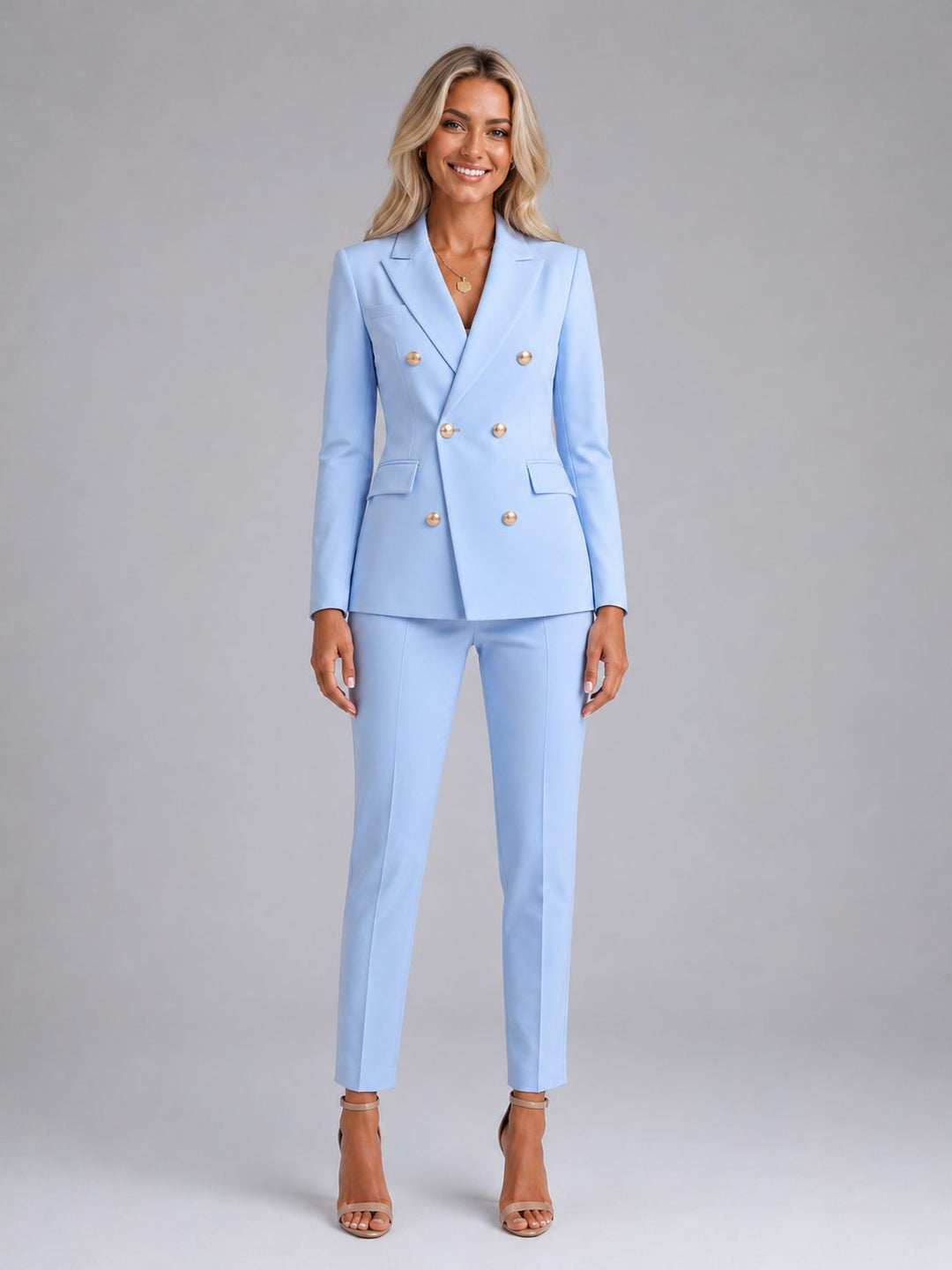 Women's double-breasted tailored blazer & slim trousers set in a professional, elegant style.