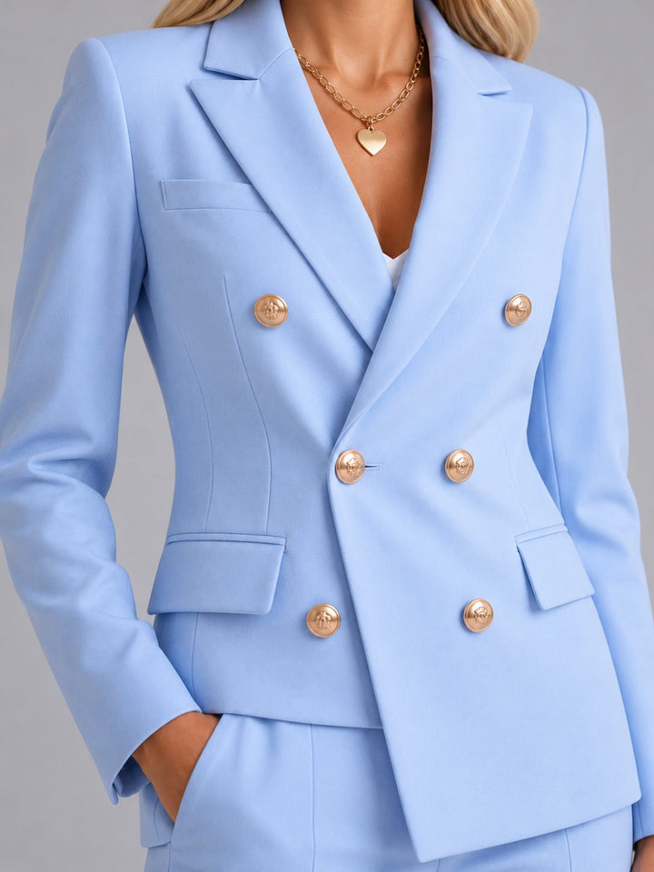 Professional women's tailored suit, double-breasted blazer and slim trousers for business attire.