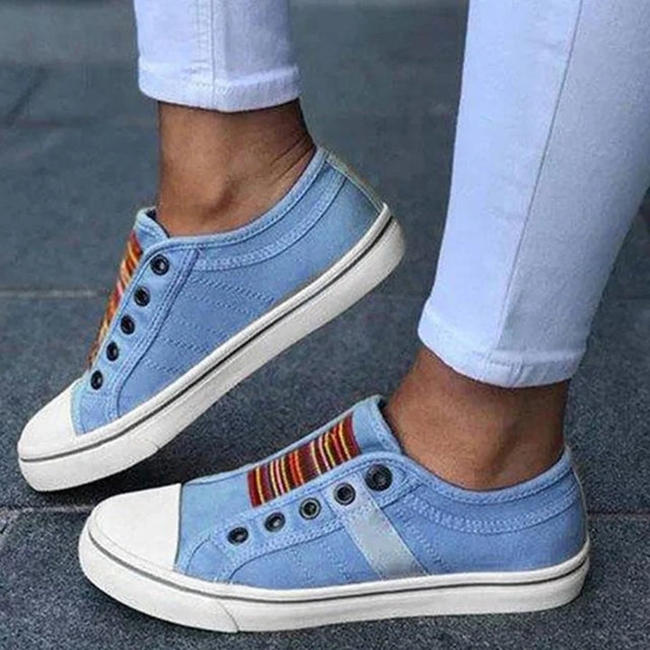Casual women's slip-on sneakers featuring classic stripes & faux laces. Comfortable low-top footwear for spring & summer.