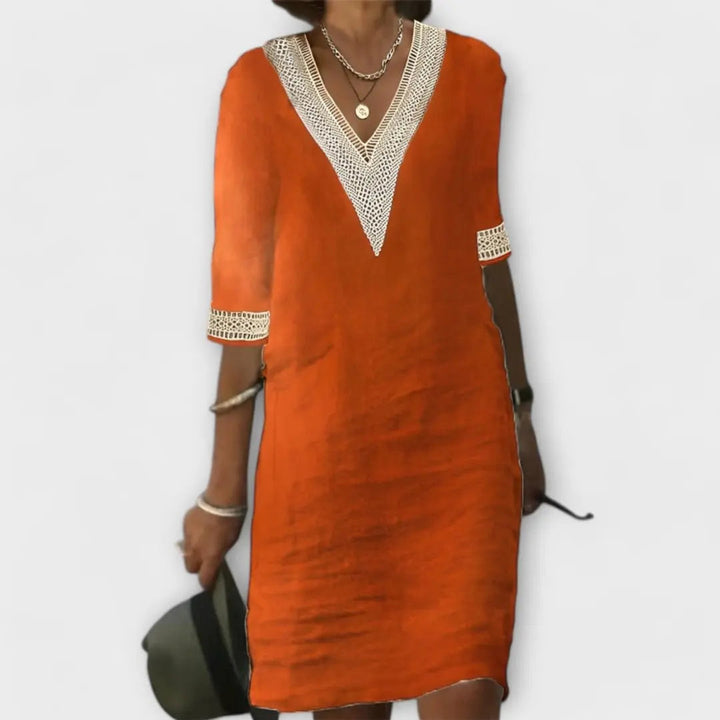 Bohemian crochet mini dress for women featuring a stylish V-neck and comfortable 3/4 sleeves. Relaxed fit.