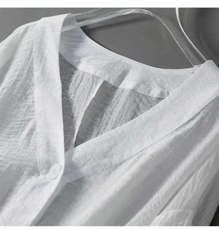 Relaxed fit women's cotton linen batwing top with button accents, perfect for a bohemian casual summer look.