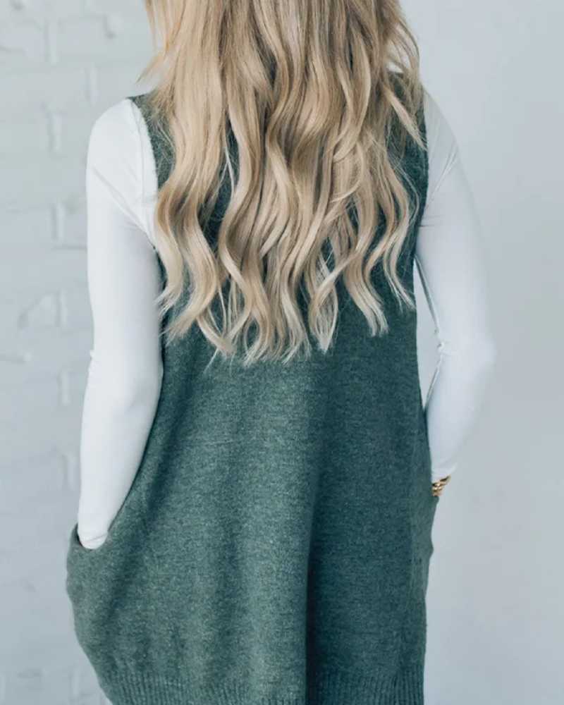 Chic grey women's sleeveless knit vest, a cozy layering piece for effortless fall and winter fashion.