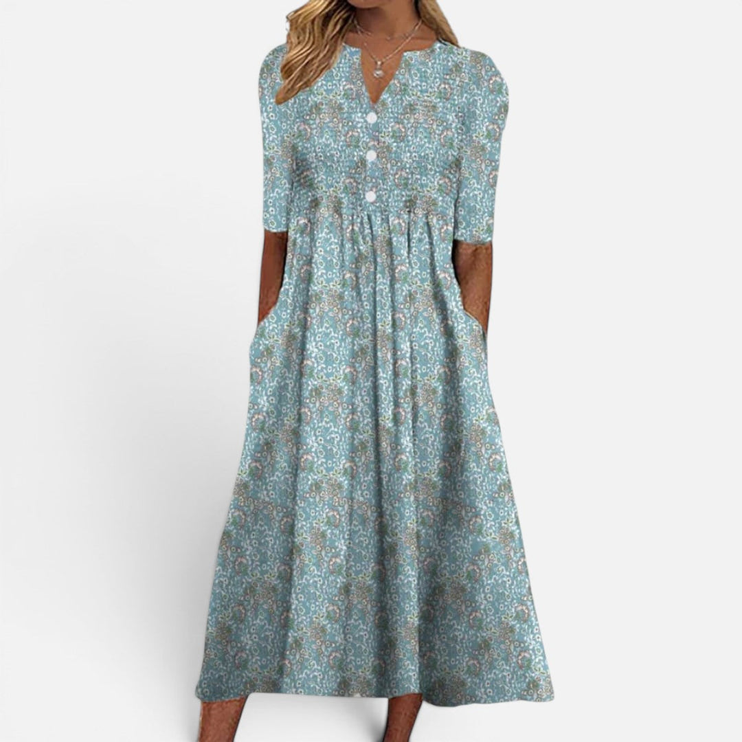 Stylish women's blue floral buttoned midi dress featuring practical pockets, ideal for casual spring and summer.