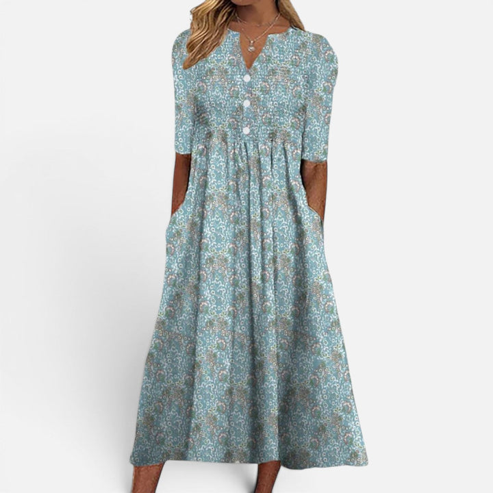Stylish women's blue floral buttoned midi dress featuring practical pockets, ideal for casual spring and summer.