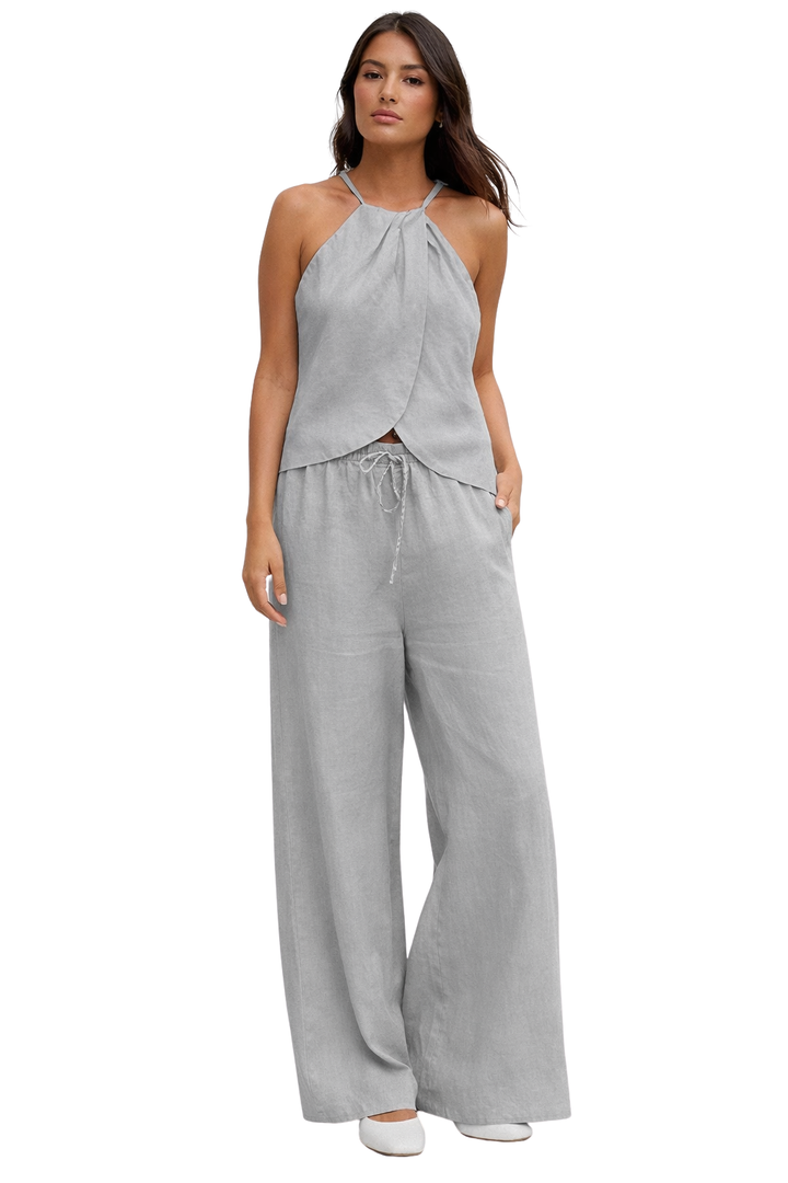 Effortless women's summer suit, a chic two-piece set with a halter top and comfortable wide leg trousers.
