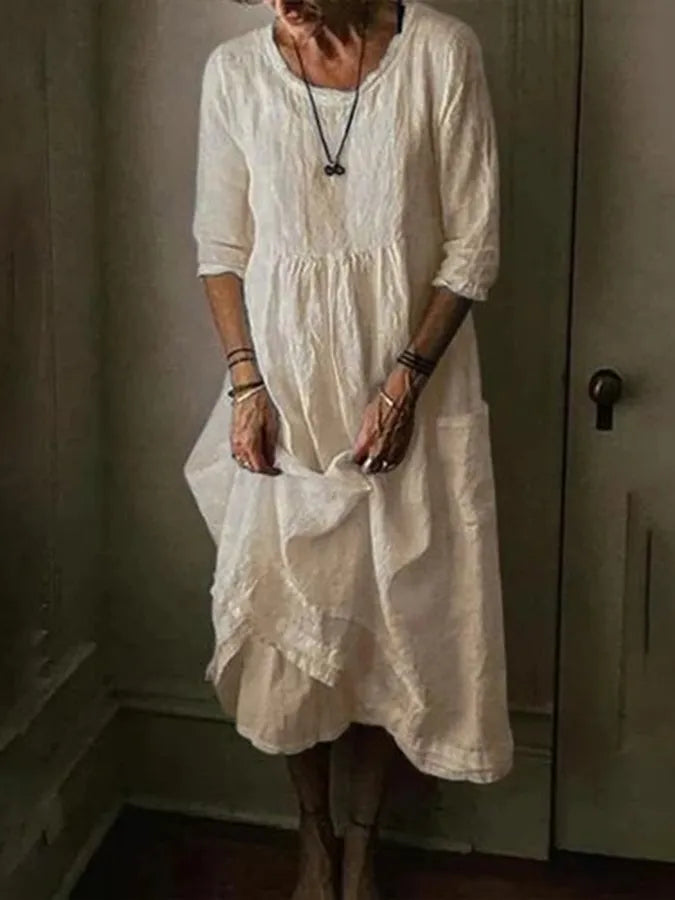 Chic women's summer midi dress featuring a relaxed loose fit, practical pockets, and a trendy asymmetric hem.
