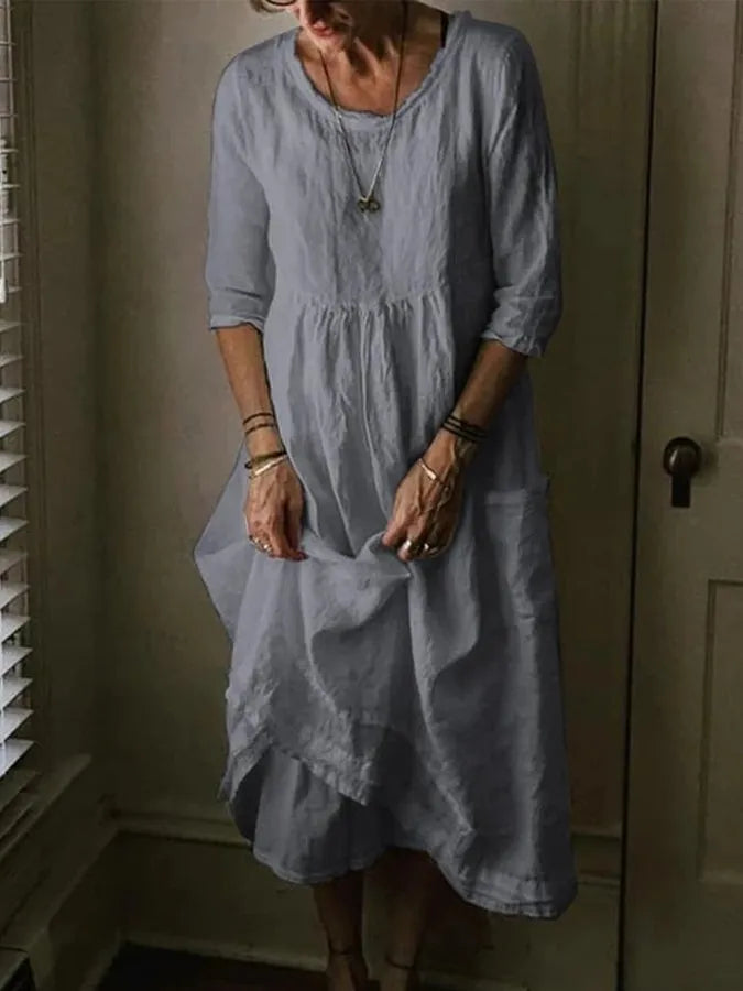 Effortless loose fit women's midi dress with convenient pockets & comfortable 3/4 sleeves, perfect for daily wear.