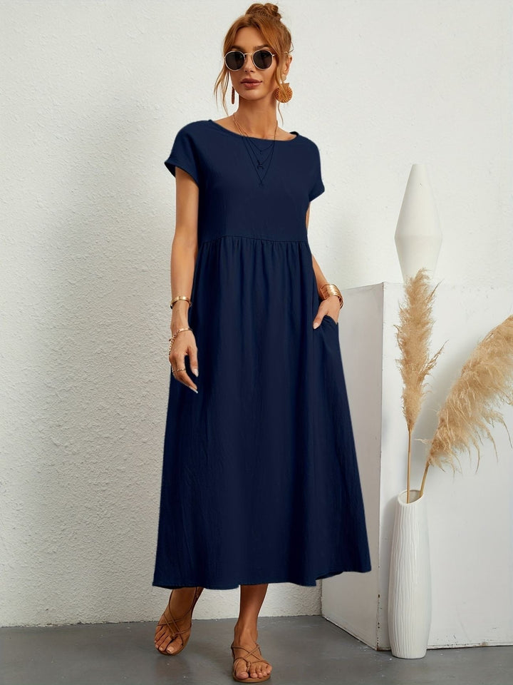 Chic women's effortless maxi dress, loose fit with round neck & convenient pockets for casual elegance.