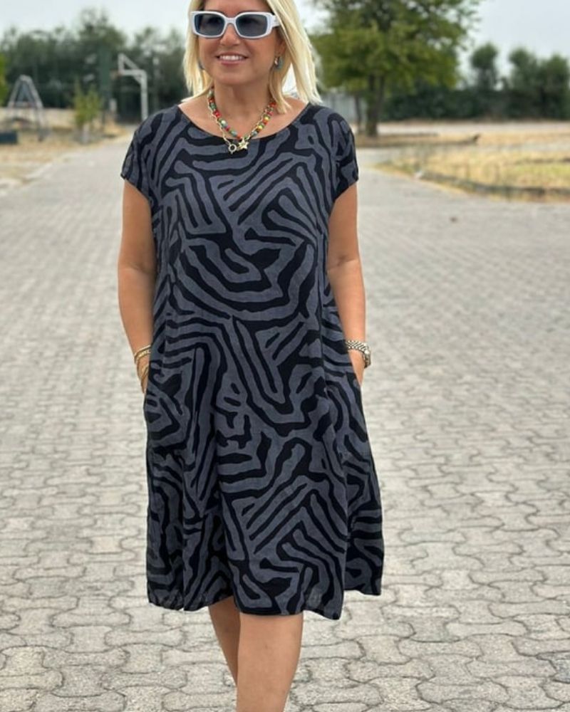 Stylish black knee-length round neck dress for women, ideal for casual summer days or comfortable everyday wear.