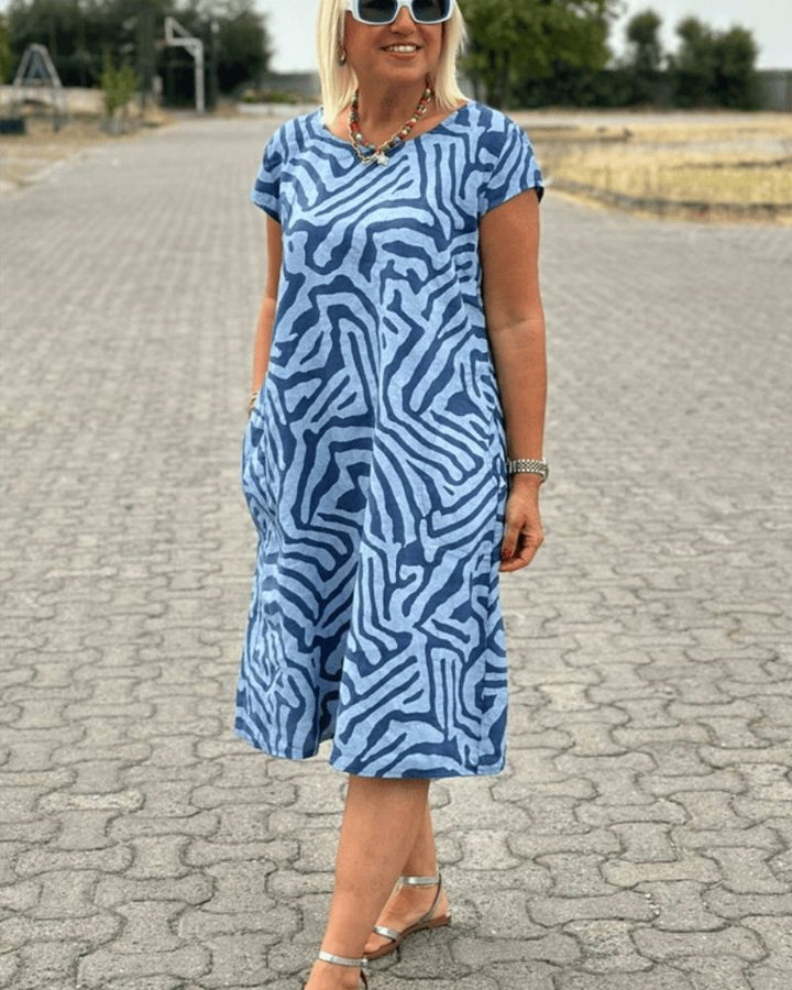 Women's comfortable round neck summer dress. Midi length, available in various colors for casual & elegant style.