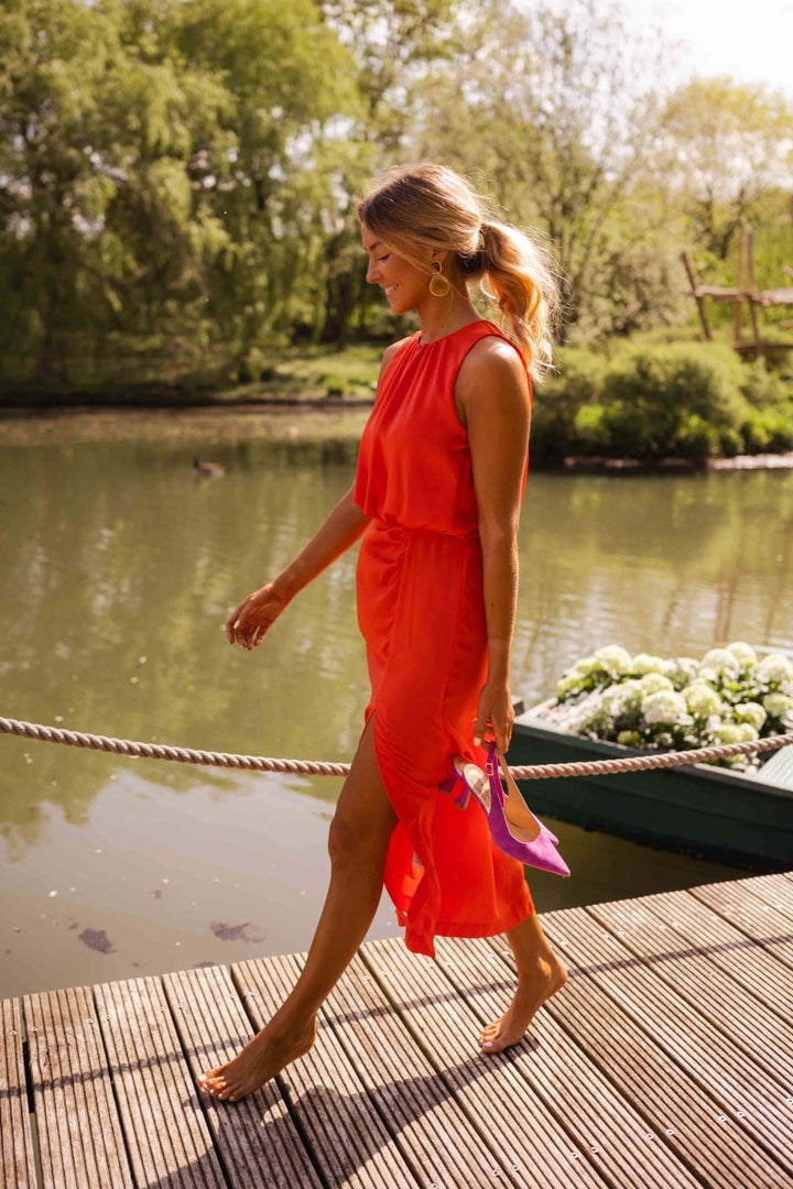 Vibrant yellow sleeveless split midi dress for women, an effortless and comfortable summer outfit.