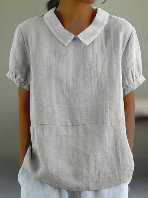 Versatile women's solid blue top, combining elegant style with casual comfort. Relaxed fit.