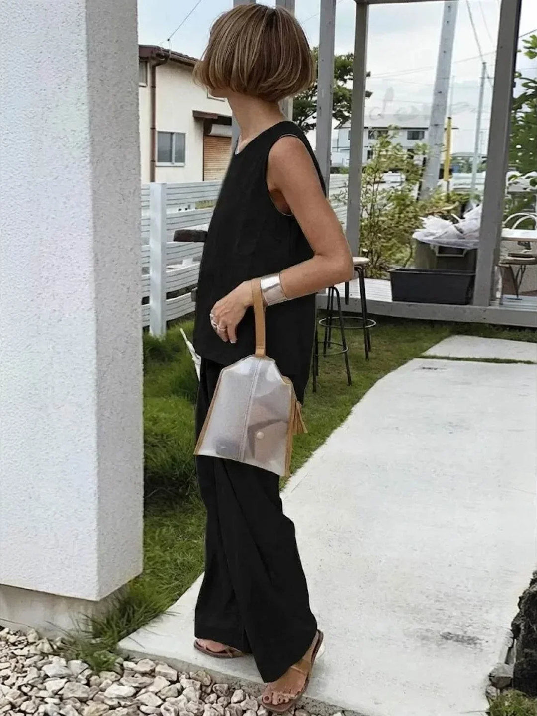 Woman standing confidently in a casual two-piece sleeveless top & wide-leg pants set, spring fashion.