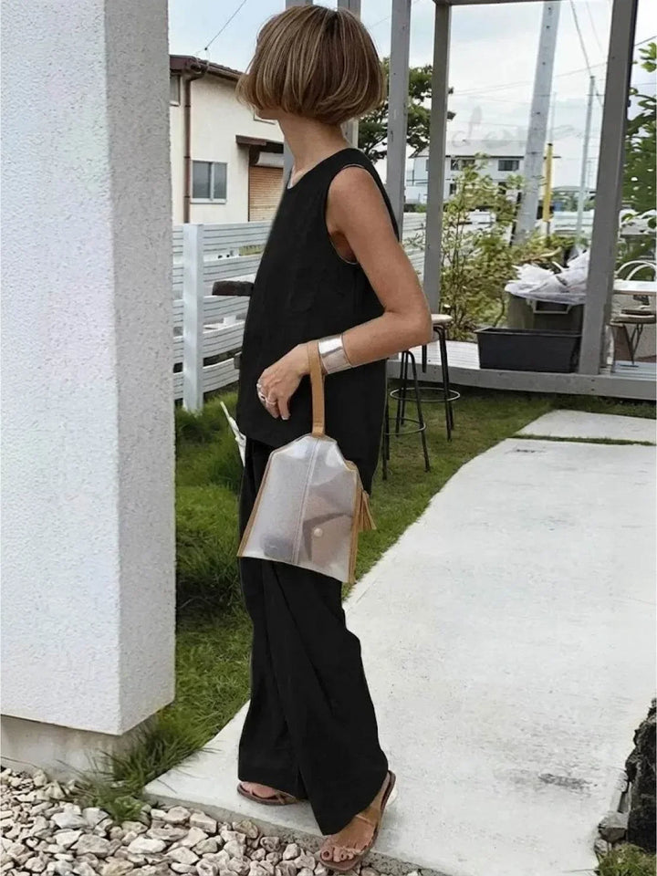Woman standing confidently in a casual two-piece sleeveless top & wide-leg pants set, spring fashion.