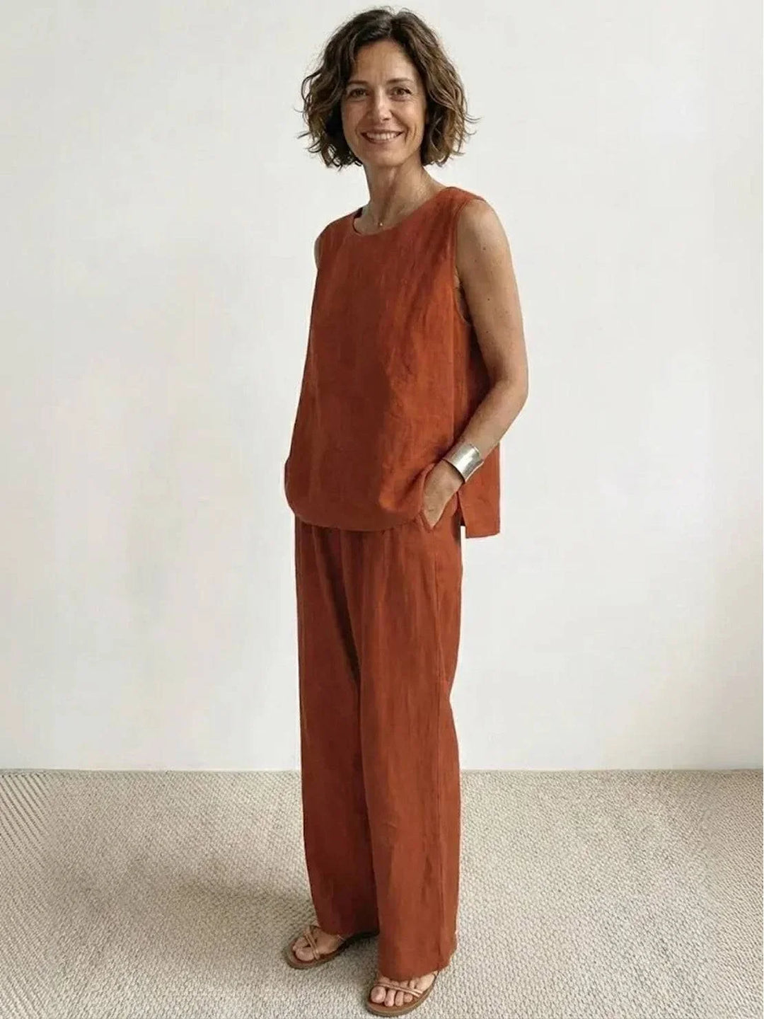 Woman enjoying an outdoor walk in a casual two-piece sleeveless top & wide-leg pants, summer fashion.
