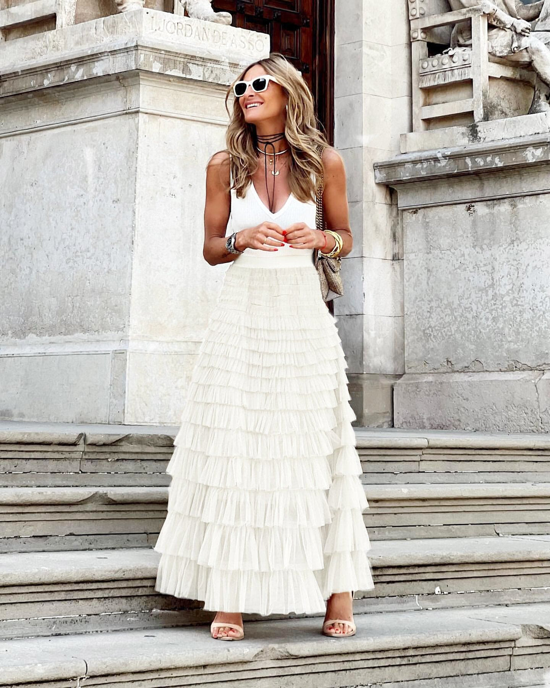 Woman walking in a chic, long A-line flowy maxi skirt, showcasing its elegance and suitability for everyday wear.