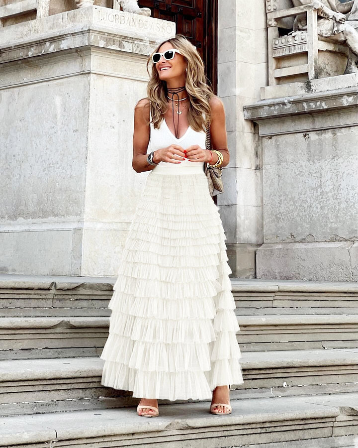 Woman walking in a chic, long A-line flowy maxi skirt, showcasing its elegance and suitability for everyday wear.