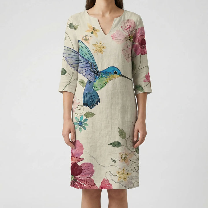 Women's elegant daytime long sleeve shift dress with an abstract floral print and v-neck.
