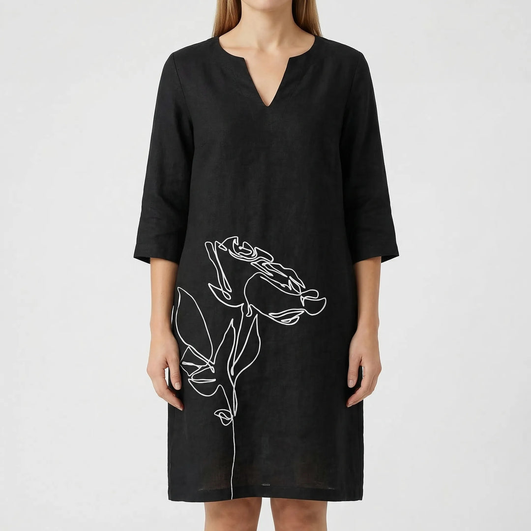 Elegant women's abstract floral print shift dress with long sleeves. Casual and fashionable choice.