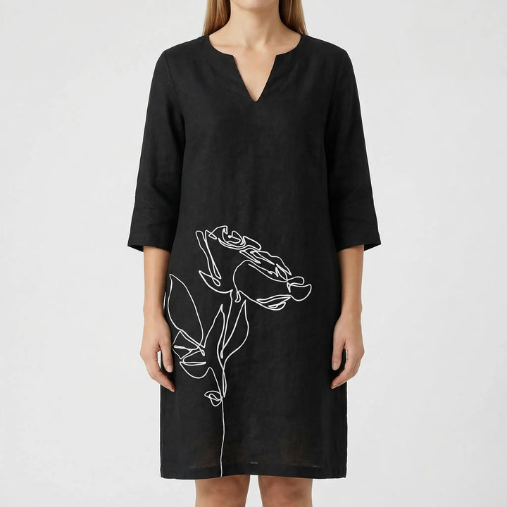Elegant women's abstract floral print shift dress with long sleeves. Casual and fashionable choice.