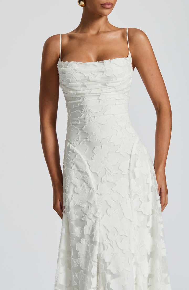 Backless maxi dress featuring delicate spaghetti straps, perfect for evenings