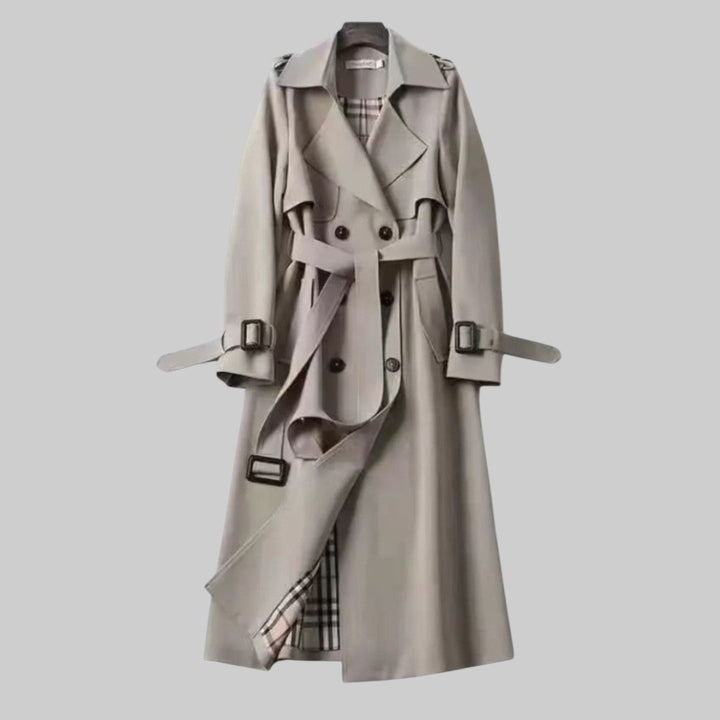 Elegant women's long trench coat, double-breasted with a belt, sophisticated outerwear for women's fashion.