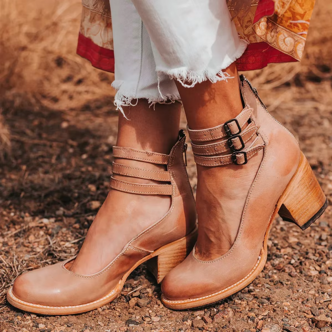 Women's elegant block heel boots with a flattering ankle strap, ideal for formal and party ensembles.
