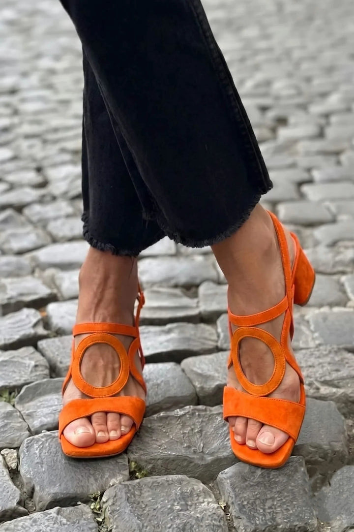Versatile women's block heel sandals with a square toe and unique ankle detail, great for casual or elegant looks.