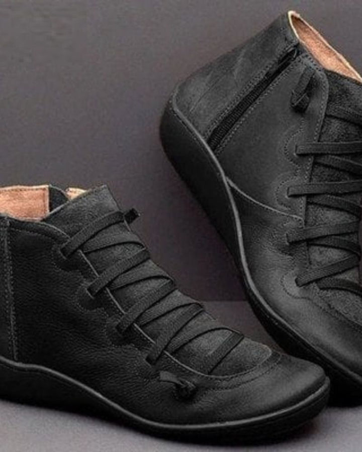 Women's elegant black leather ankle boots, stylish everyday footwear.