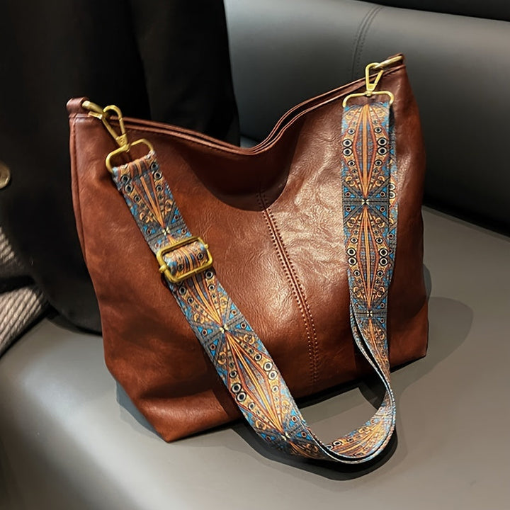 Stylish brown leather tote bag for women, featuring a chic shoulder strap and ample space.